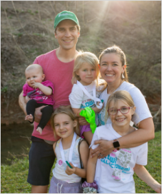 A family standing outside at the GLOW fundraising race